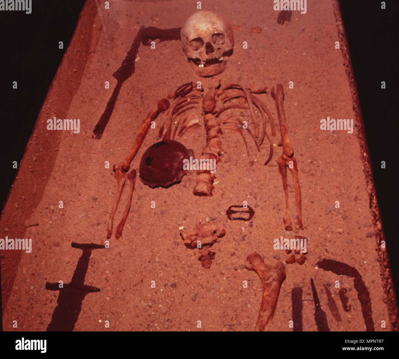 Viking Burial of Man with Axe, Spear, Sword , Knives, Shield and Belt Buckle, 9th-10th century. Artist: Unknown. Stock Photo