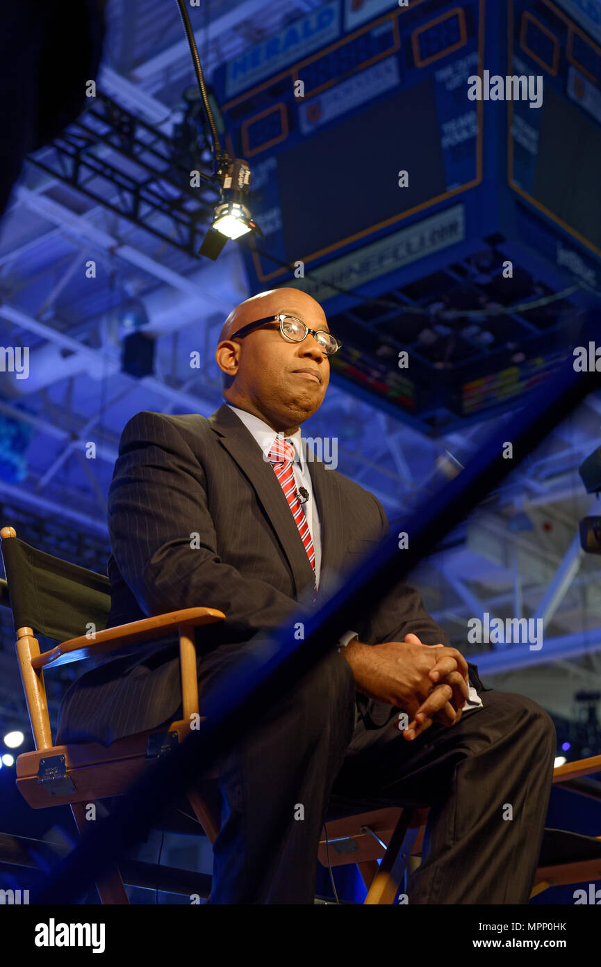 Long Island, USA. 23rd May, 2018. Reporter, sitting on media riser, tapes political news segment during Day 1 of New York State Democratic Convention, held at Hofstra University on Long Island. Credit: Ann E Parry/Alamy Live News Stock Photo