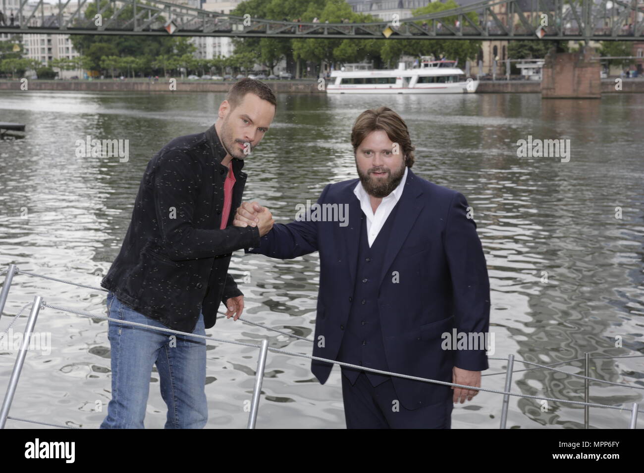 Frankfurt, Germany. 24th May 2018. Actors Wanja Mues (left) and Antoine Monot, Jr. (right) pose on the gangway of the houseboat that is owned by Mues' character Leo in the TV show. 4 new episodes of the relaunch of the long running TV series 'Ein Fall fuer zwei’ (A case for two) are being filmed in Frankfurt for the German state TV broadcaster ZDF (Zweites Deutsches Fernsehen). It stars Antoine Monot, Jr. as defence attorney Benjamin ‘Benni’ Hornberg and Wanja Mues as private investigator Leo Oswald. The episodes are directed by Thomas Nennstiel. The episodes are set to air in October. Stock Photo