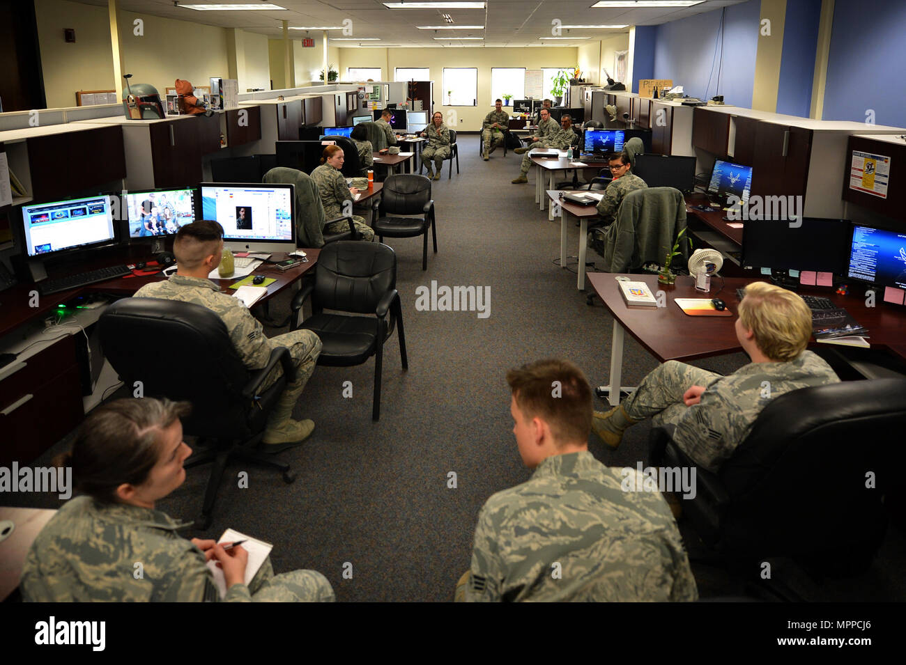 U.S. Airmen assigned to the 20th Fighter Wing (FW) Public Affairs (PA) office meet for a productivity meeting at Shaw Air Force Base, S.C., March 21, 2017. Photojournalists assigned to the 20th FW PA office are tasked with documenting base operations, as well as taking and distributing official studio and passport photos for Airmen who are applying for award packages and preparing for deployments and permanent change of stations. (U.S. Air Force photo by Airman 1st Class Christopher Maldonado) Stock Photo