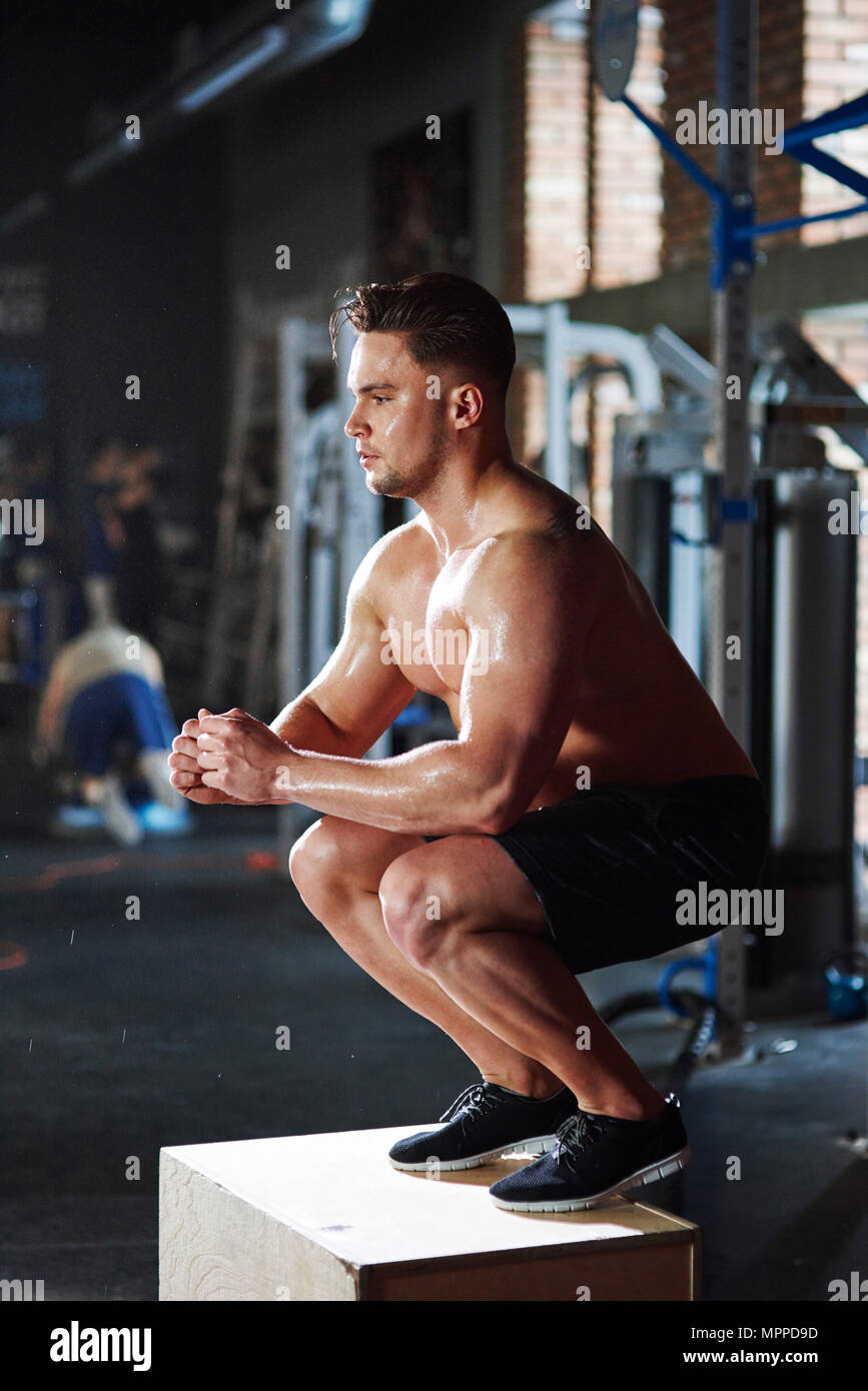 Man doing exercises at gym Stock Photo