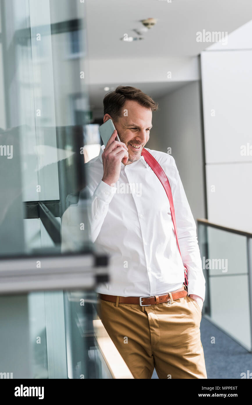 Smiling businessman talking on cell phone Stock Photo