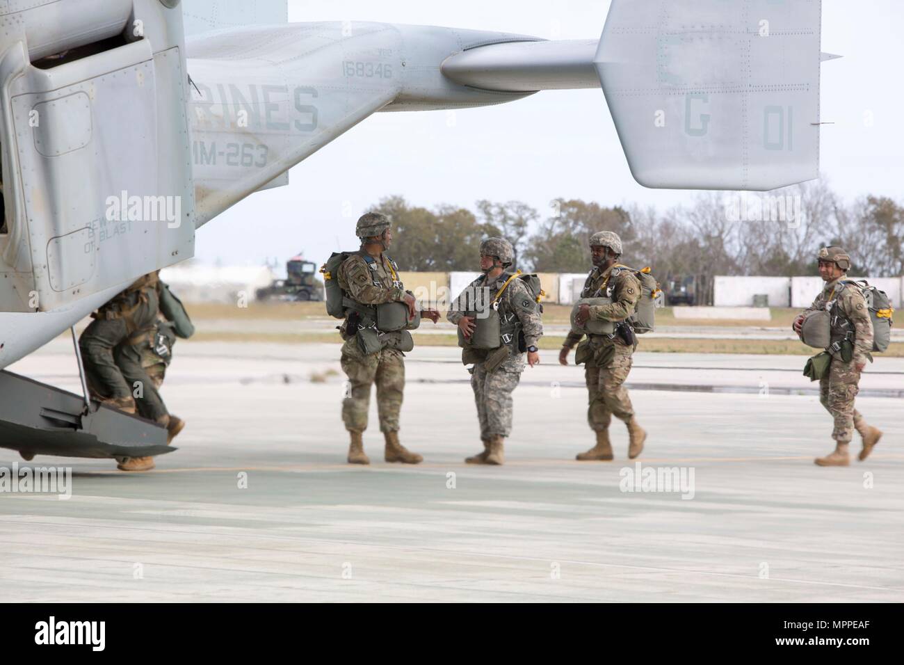 Soldiers board an MV-22B Osprey during an air-drop delivery jump exercise with the Marine Corps at Marine Corps Auxiliary Landing Field Bogue, N.C., March 27, 2017. The Soldiers participated in field exercise Bold Bronco 17, allowing Marines and Soldiers to get exposure working together on transportation operations. The Soldiers are with 647th Quartermaster Company, 3rd Expeditionary Sustainment Command. (U.S. Marine Corps photo by Sgt. Clemente C. Garcia) Stock Photo