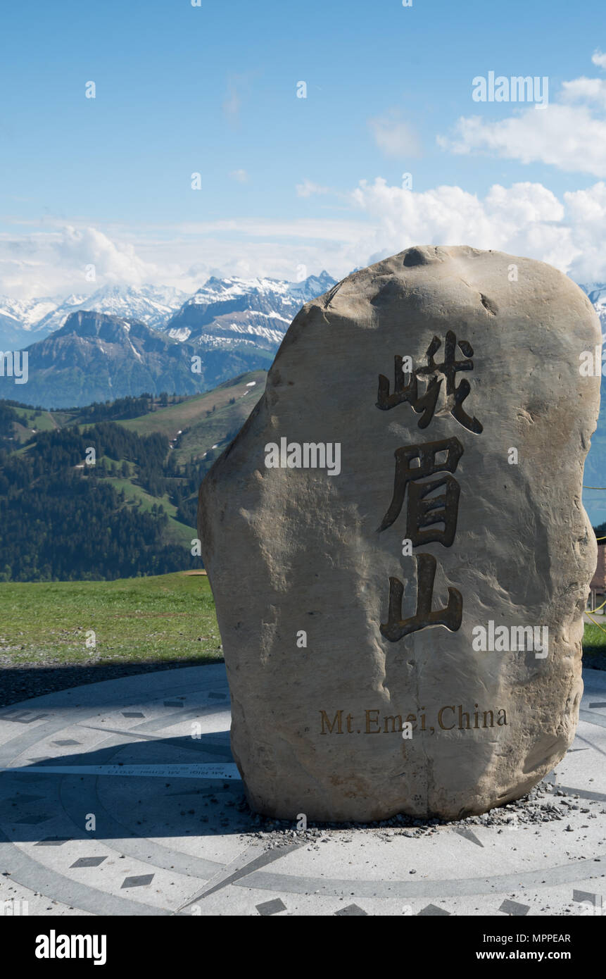 Boulder taken from Mt Emei at the top of its sister mountain of rigi with mountains in the background Stock Photo