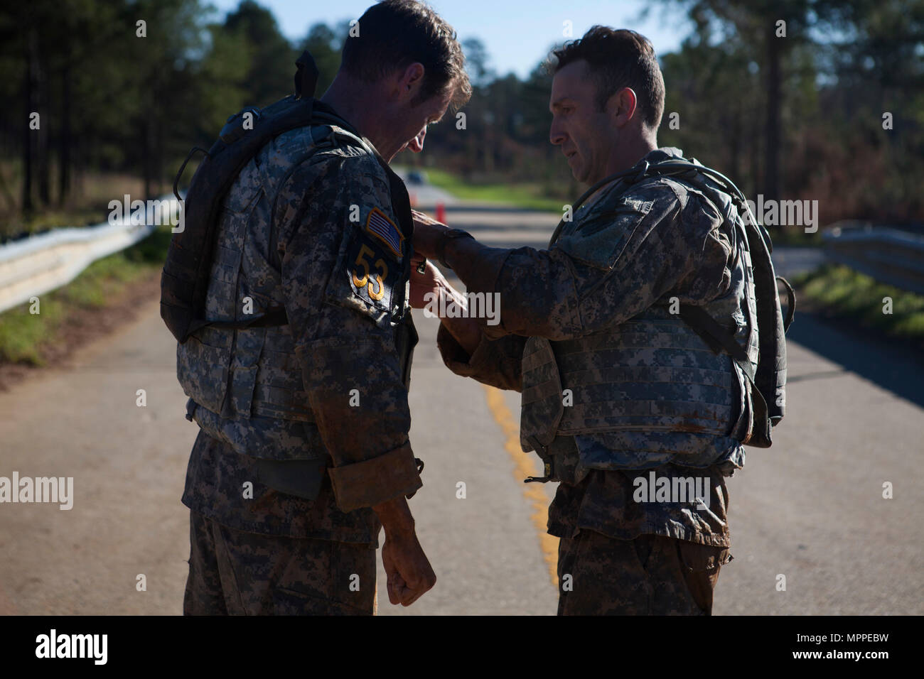 U.S. Army Rangers adjust their water supplies during the Body Armor run ...