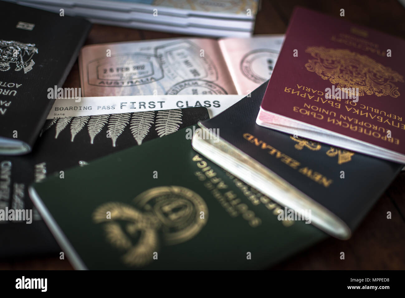 Multiple passports with visas and entry stamps and a First Class ticket