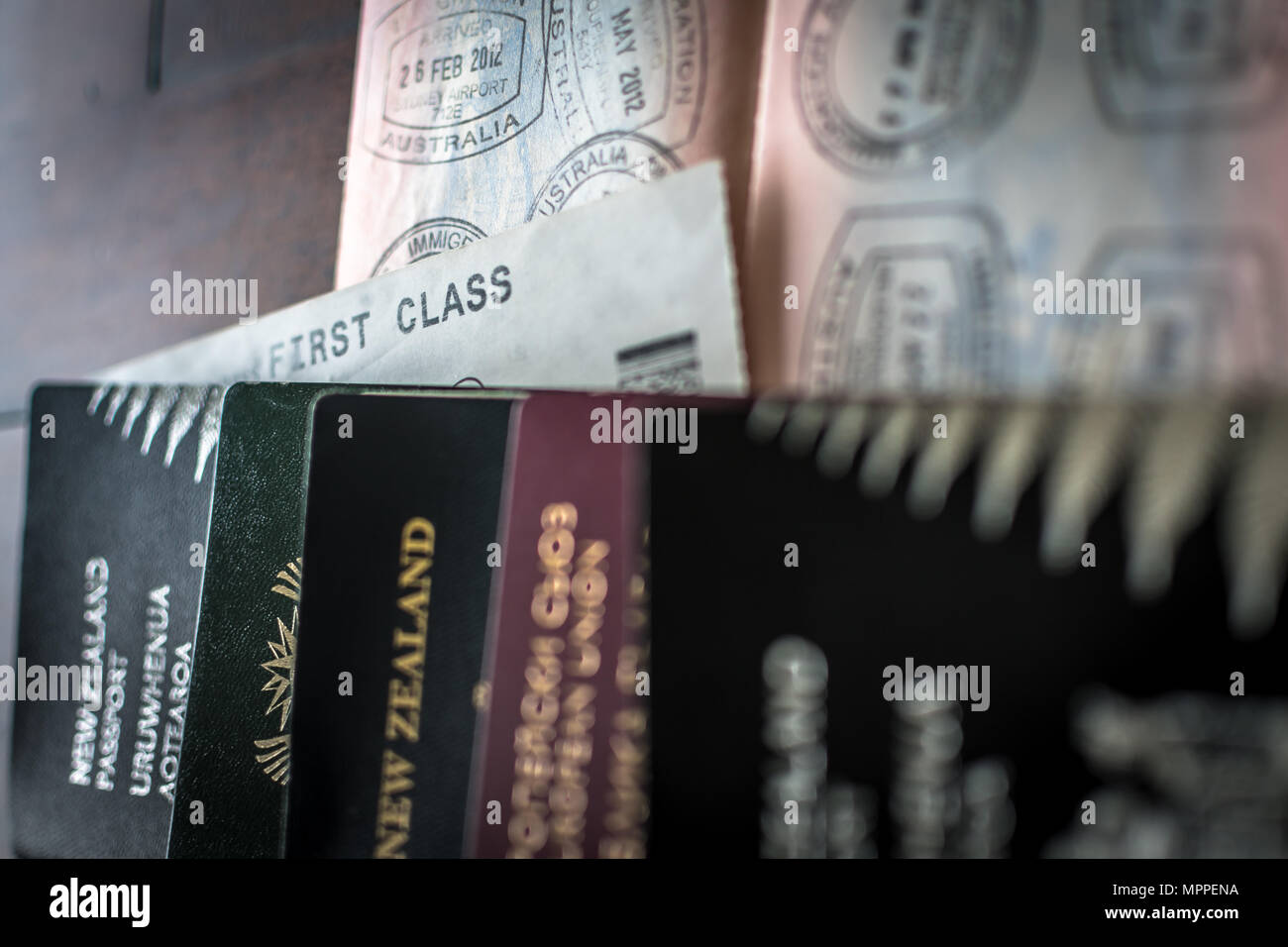 Multiple passports with visas and entry stamps and a First Class ticket