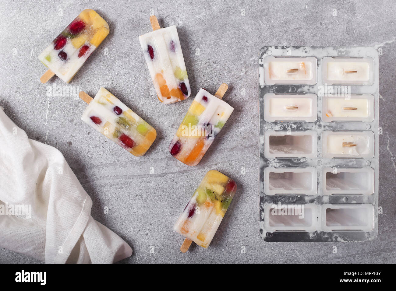 Homemade fruits and yogurt ice lollies on marble Stock Photo Alamy