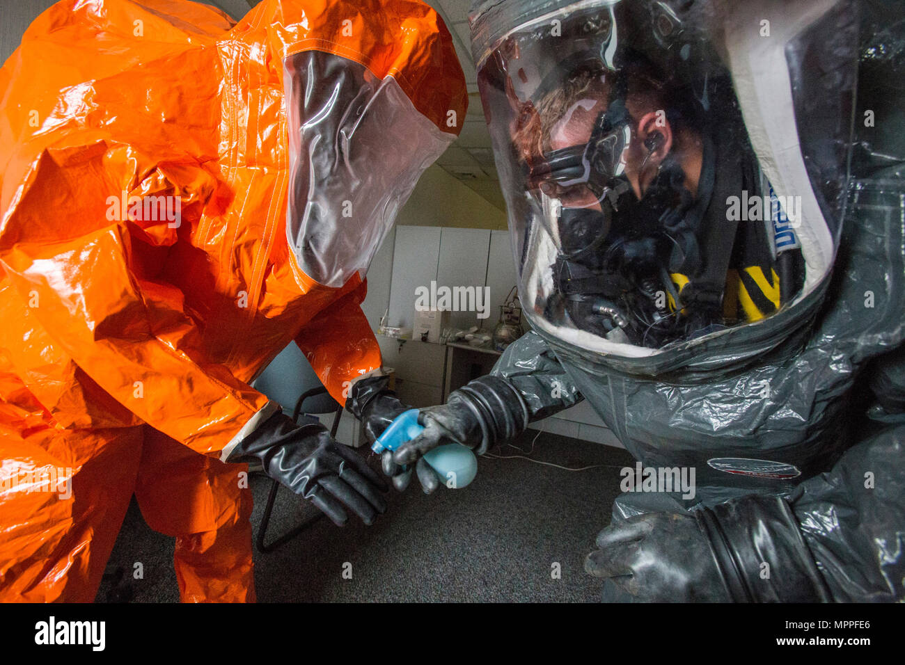 Sgt. Cory Sweetman, right, sanitizes Sgt. Quran Williams, both with the