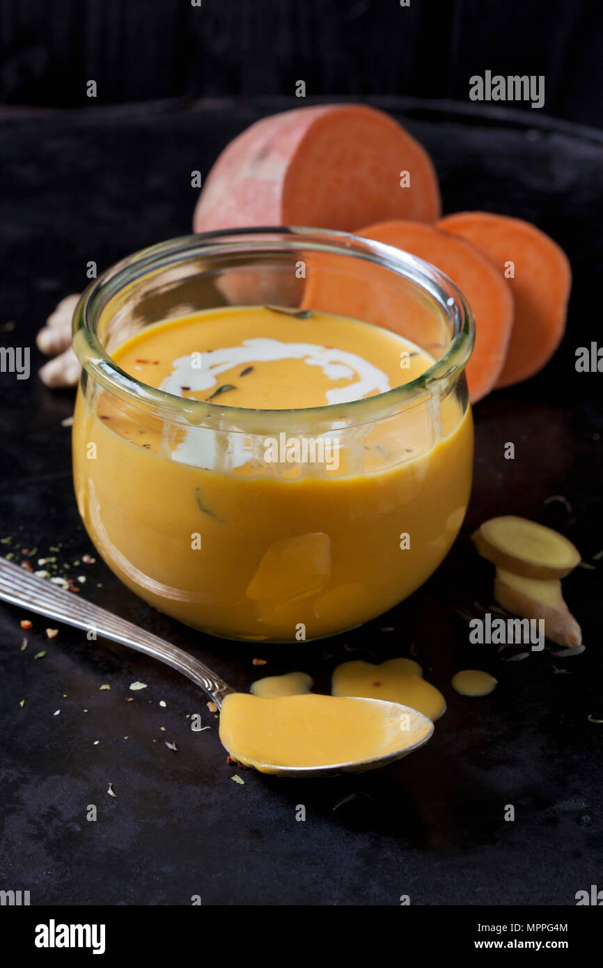 Glass of sweet potato soup with ginger and cream Stock Photo
