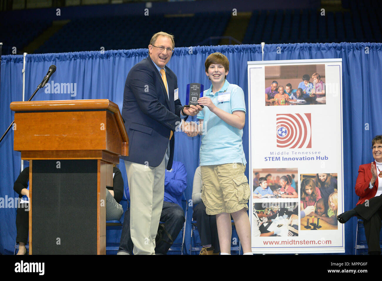 Jimmy Waddle, U.S. Army Corps of Engineers Nashville District Engineering and Construction Division chief, presents an award to Carson Fisher, 7th grade student from Robert E. Ellis Middle School in Hendersonville, Tenn., during the Science, Technology, Engineering and Mathematics Expo at Tennessee State University Gentry Center April 6, 2017. He was presented with a glass trophy and certificate for his project, a self-rising levee system. Stock Photo