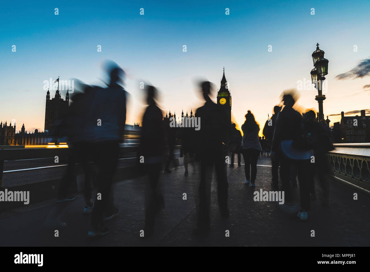 UK, London, silhouette of people on Westminster bridge with Big Ben in background at sunset Stock Photo