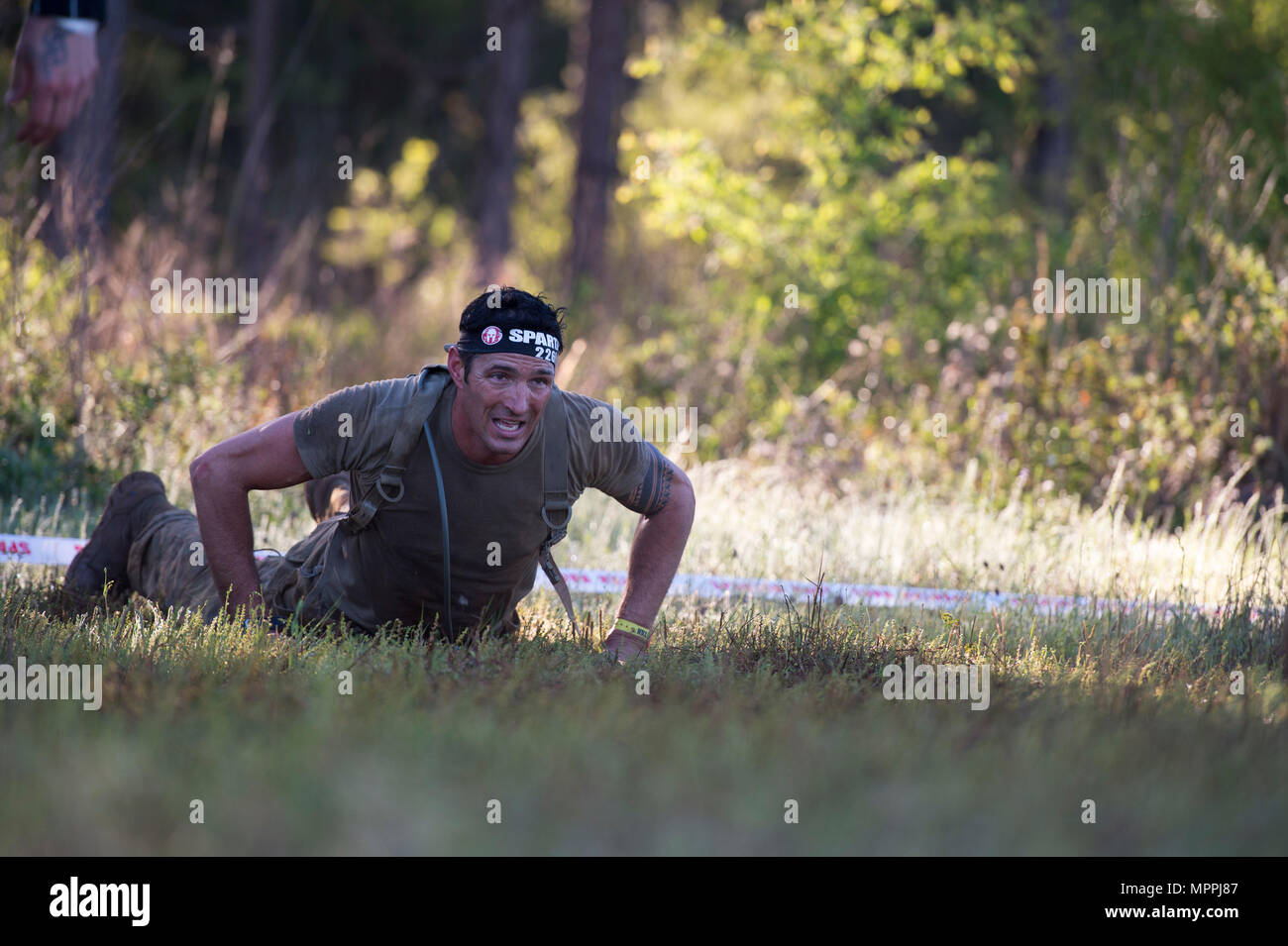 A U.S. Army Ranger performs burpees while competing in the Spartan Race ...