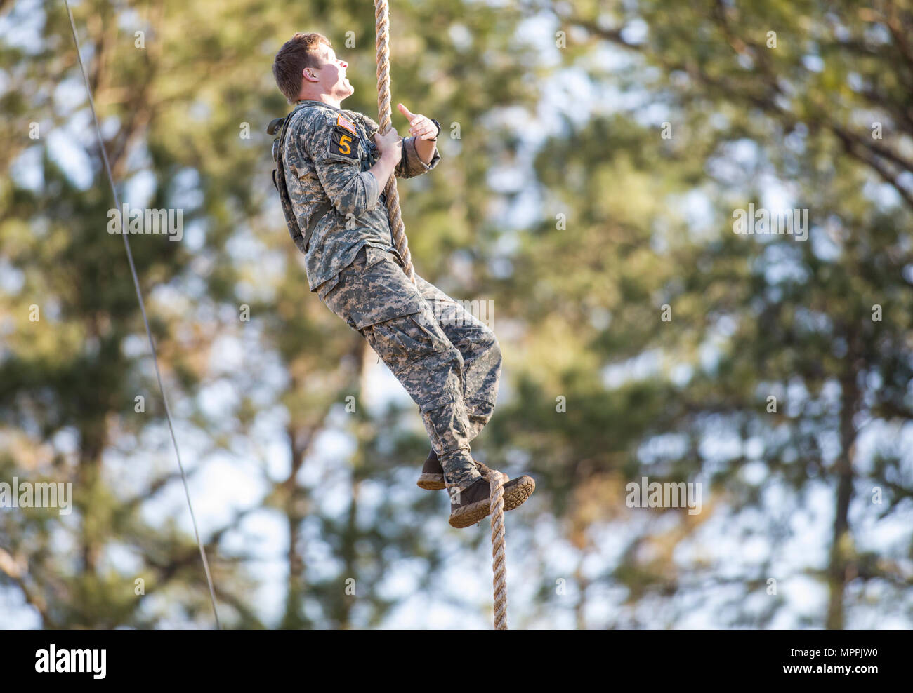 A U.S. Army Ranger from the 4th Infantry Division climbs a rope ...