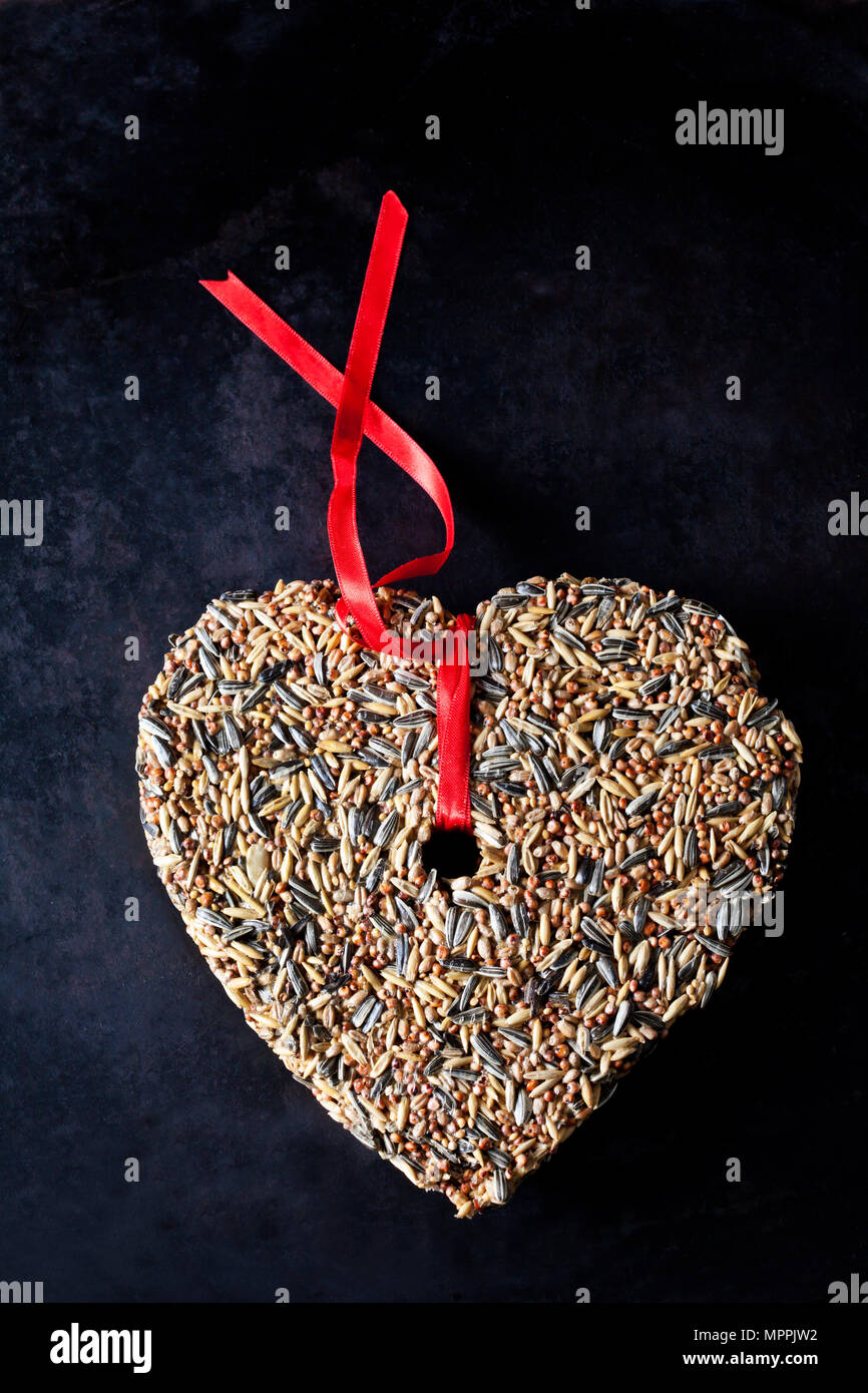 Birdseed shaped as a heart Stock Photo Alamy