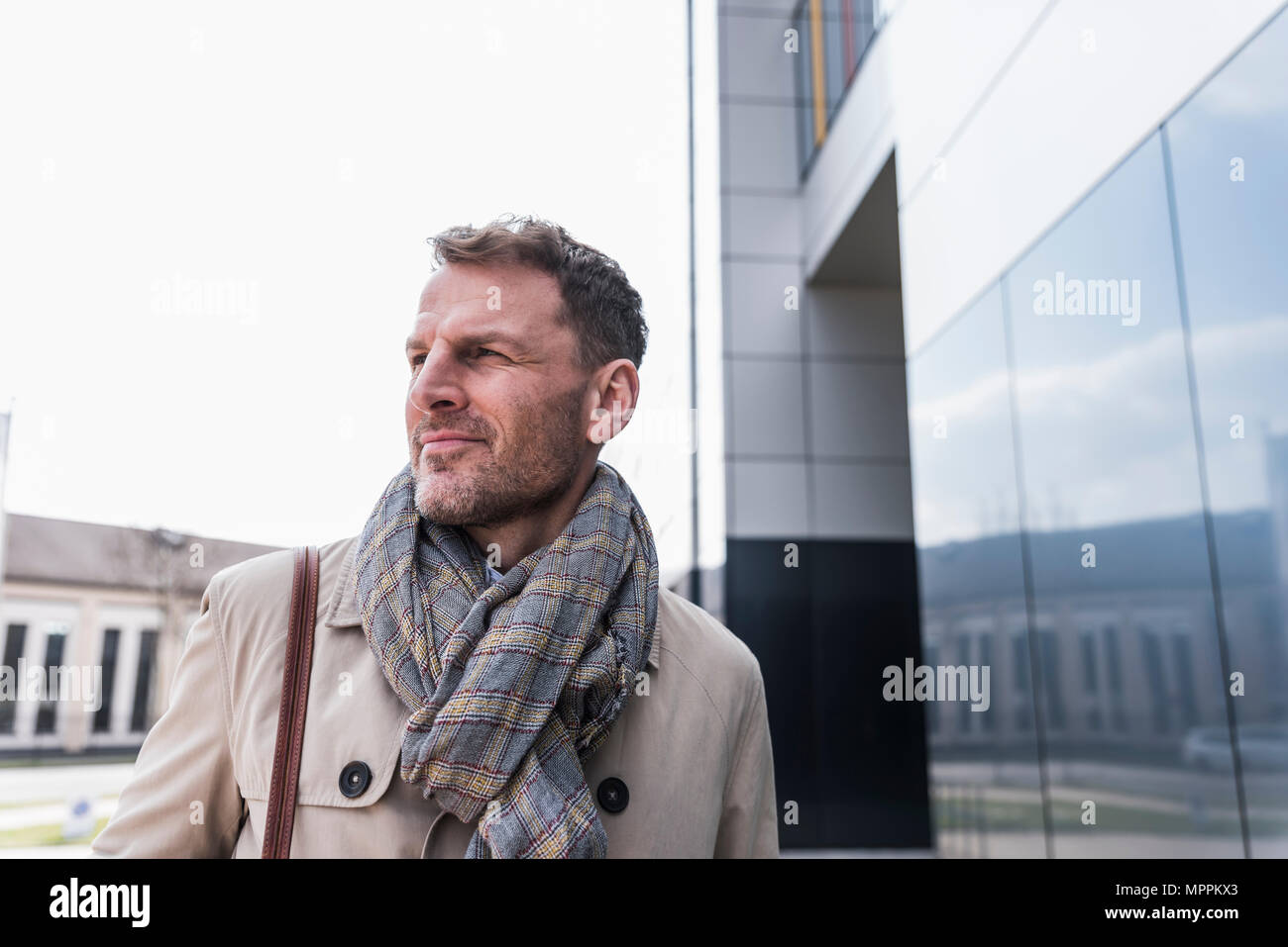 Portrait of businessman outside office building looking away Stock Photo