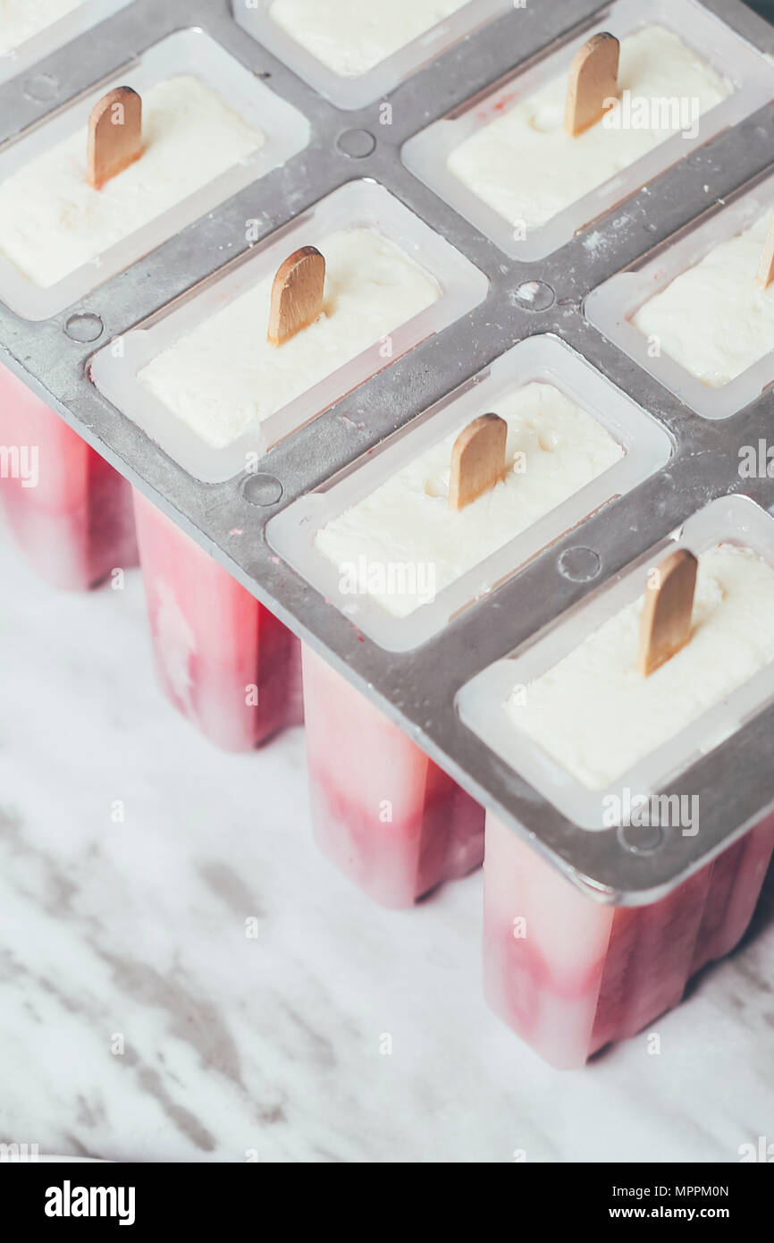 Homemade strawberry and yogurt ice lollies Stock Photo