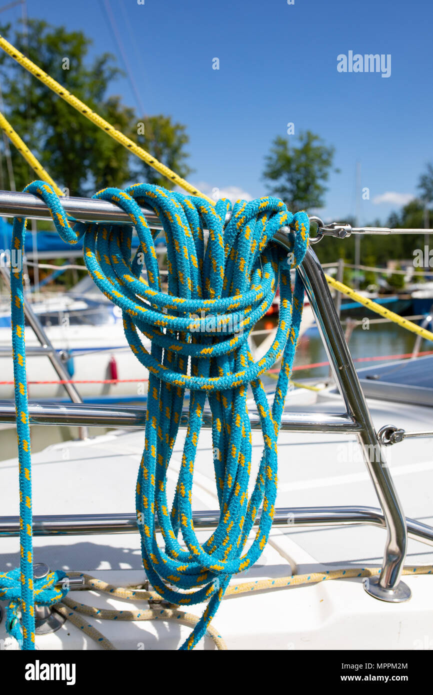 Hawser bight, mooring line. Pulleys and ropes, sheets and halyards or cleats on a yacht. Sailors world, sailing boat equipment. Stock Photo