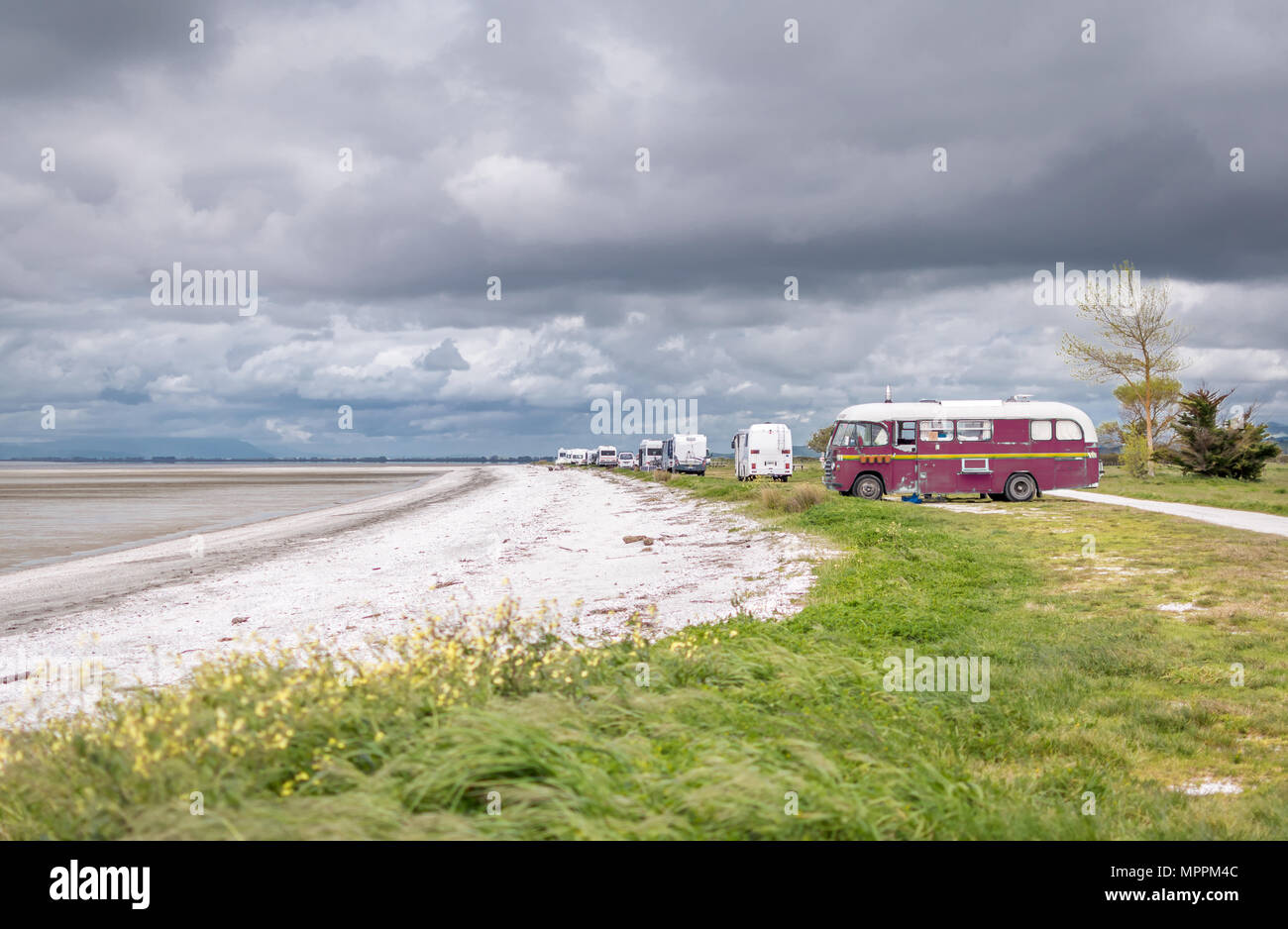 Bus and campervans on the beach front Stock Photo