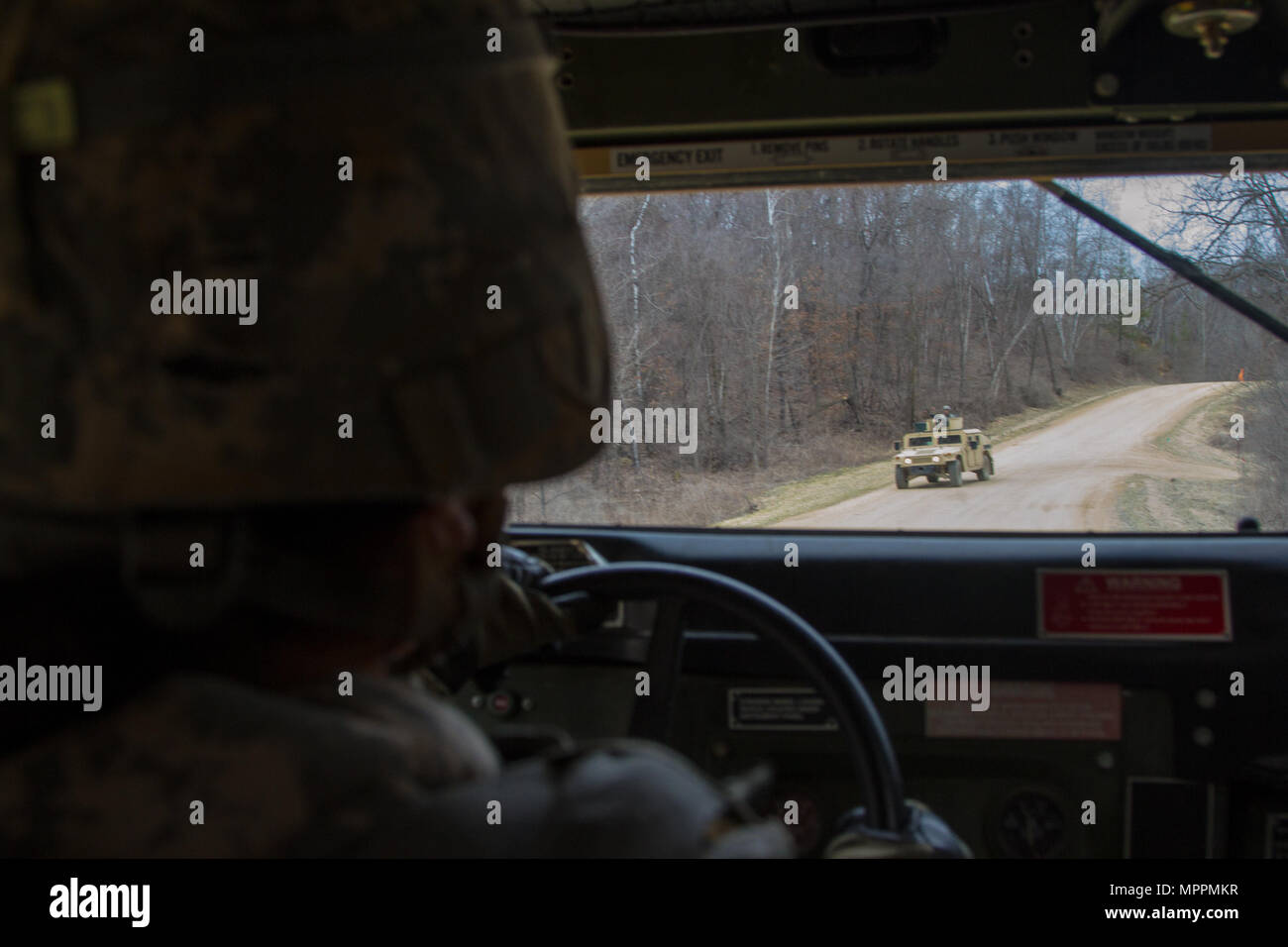 US Army Spc. Jessica Taylor, a civil affairs specialist with the 364th Civil Affairs Brigade, 351st Civil Affairs Command, maneuvers a Humvee during a firing exercise as part of Operation Cold Steel at Fort McCoy, Wis., on April 02, 2017. The 351st CACOM is responsible for strategic operations through tactical civil affairs support across the U.S. Pacific Command area of responsibility. Operation Cold Steel is the U.S. Army Reserve’s crew-served weapons qualification and validation exercise to ensure that America’s Army Reserve units and Soldiers are trained and ready to deploy on short-notice Stock Photo