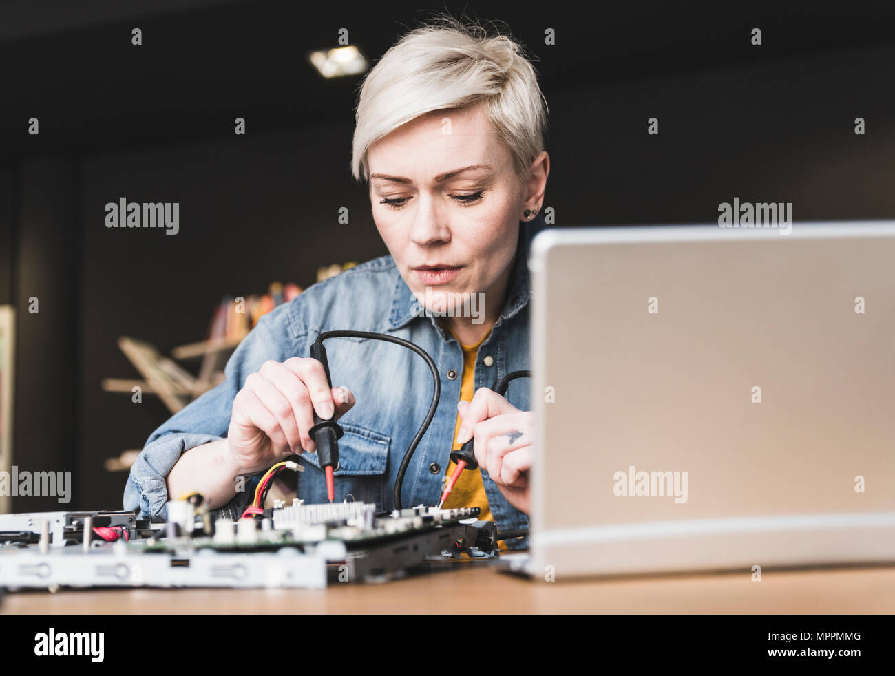 Woman working on computer equipment Stock Photo