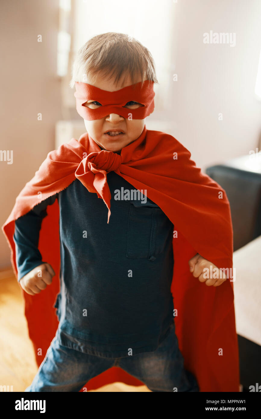 Portrait of little boy dressed up as a superhero at home Stock Photo