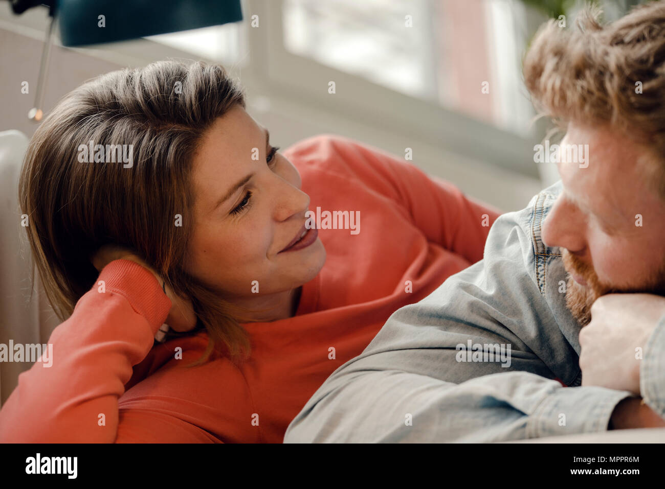 Happy couple at home talking and listening to each other Stock Photo