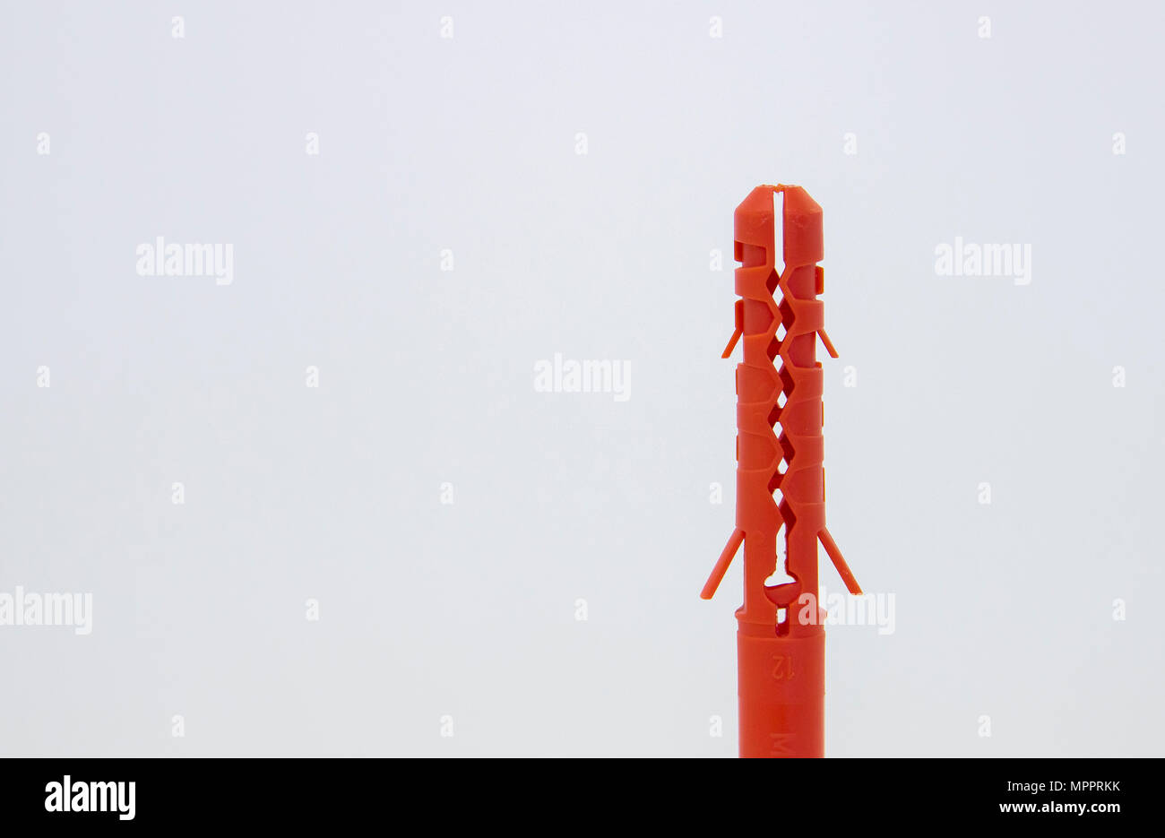 One plastic orange dowel on white background Stock Photo