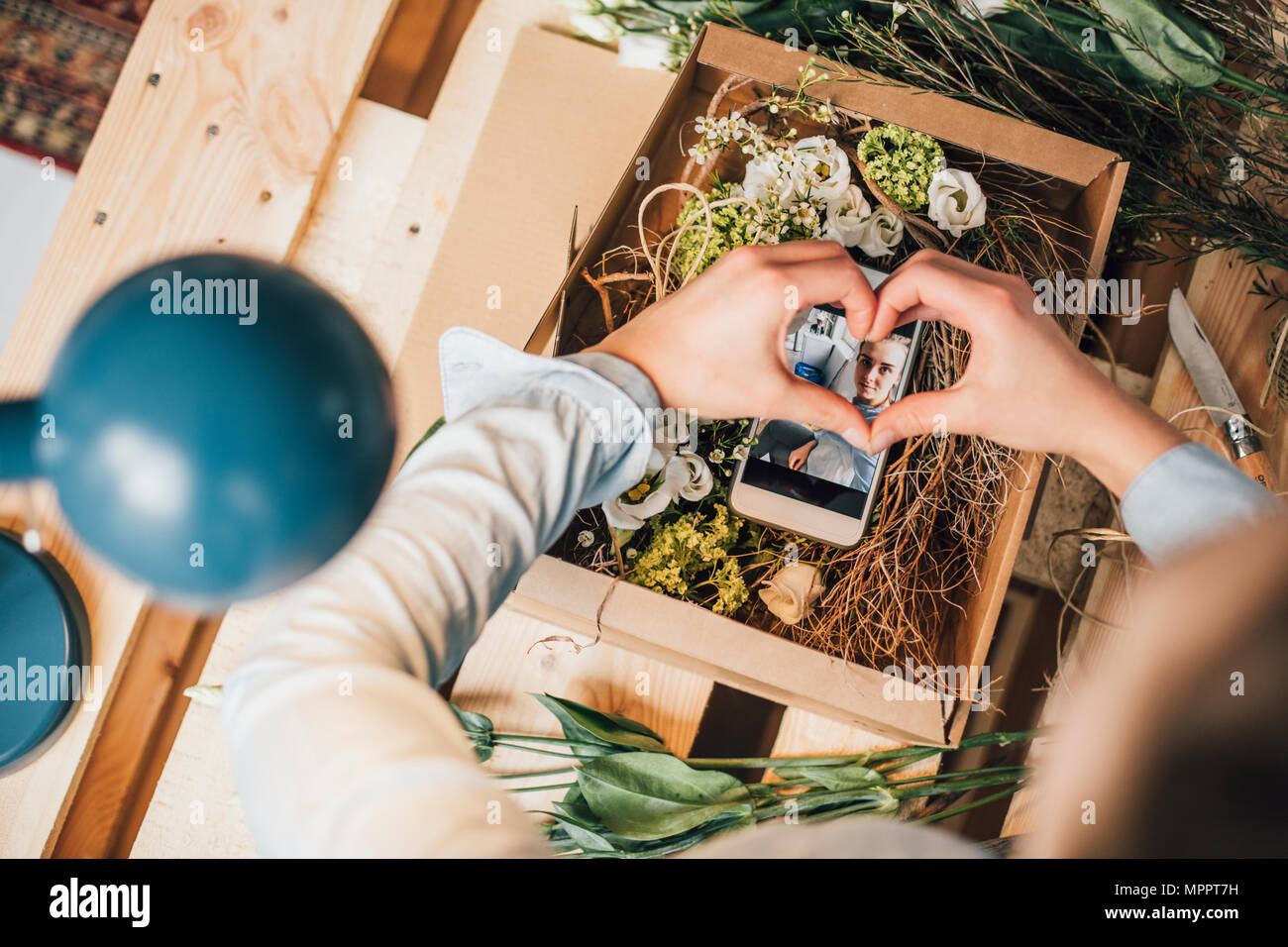 Woman arranging present in a box, partial view Stock Photo