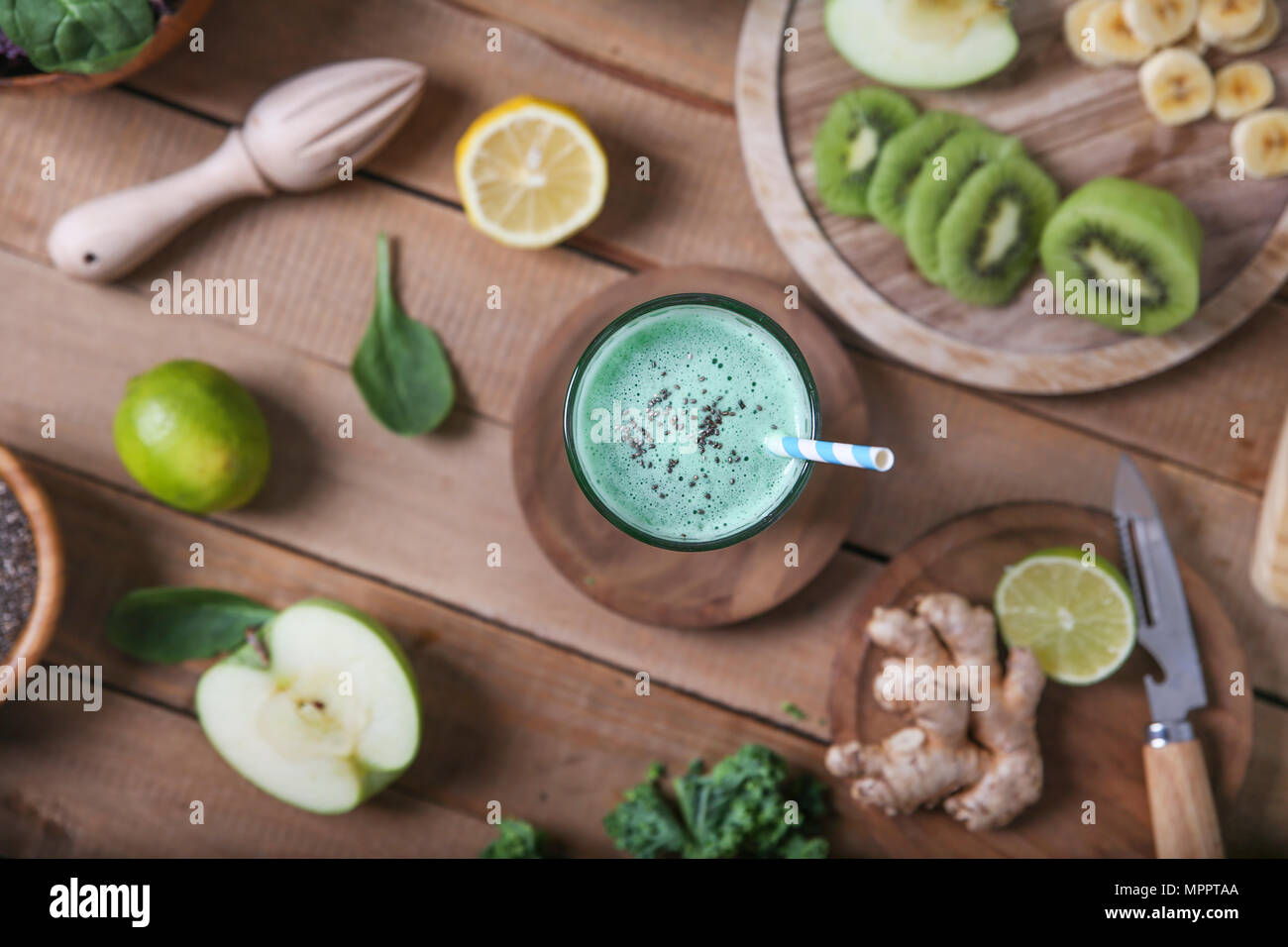 Green smoothie surrounded by ingredients Stock Photo