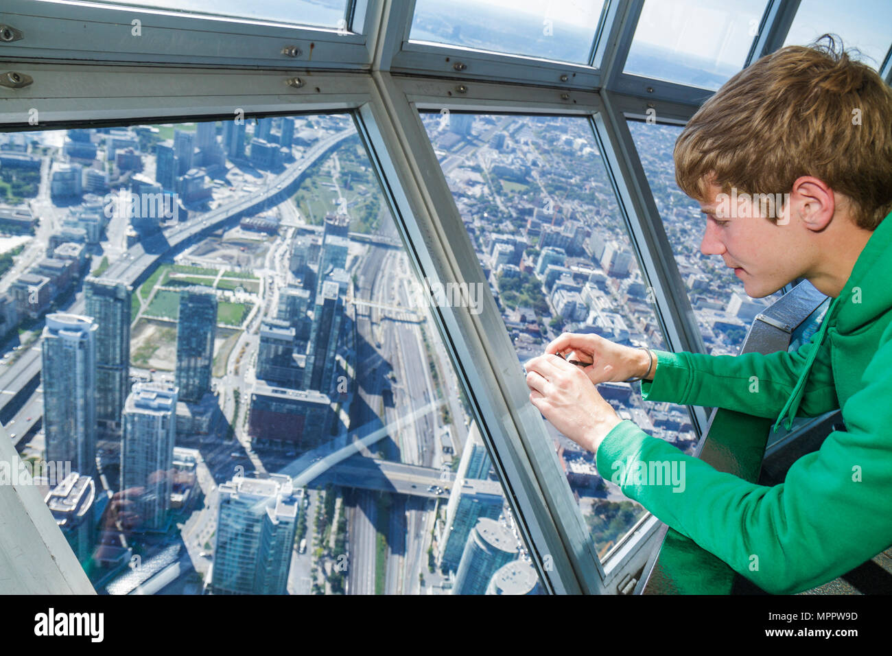 Toronto Canada,Bremner Boulevard,CN Tower,observation towermodern wonder,Sky Pod,window view west,boy teen,taking urban,aerial overhead view from abov Stock Photo