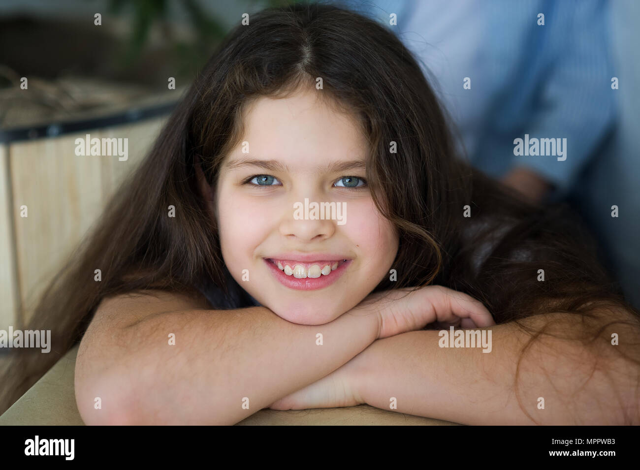 Portrait of a girl 1011 years old. ?ute girl looks at the camera and