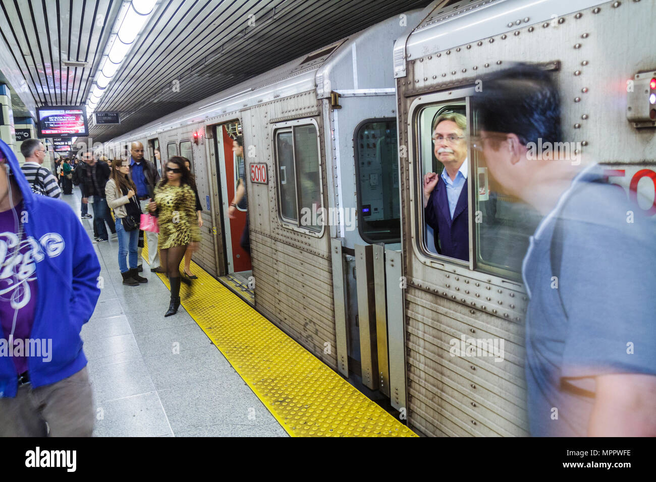 Toronto Canada,College Station,Yonge Yellow Line,TTC,Toronto Transit Commussion,subway,train,train,public transportation,boarding,commuter,commuters,a Stock Photo