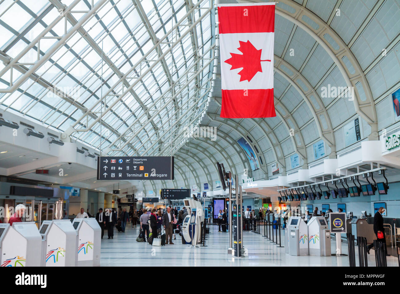 Toronto Canada,Lester B. Pearson International Airport,YYZ,aviation,terminal,ticket counter,self service check in kiosk,passenger passengers rider rid Stock Photo