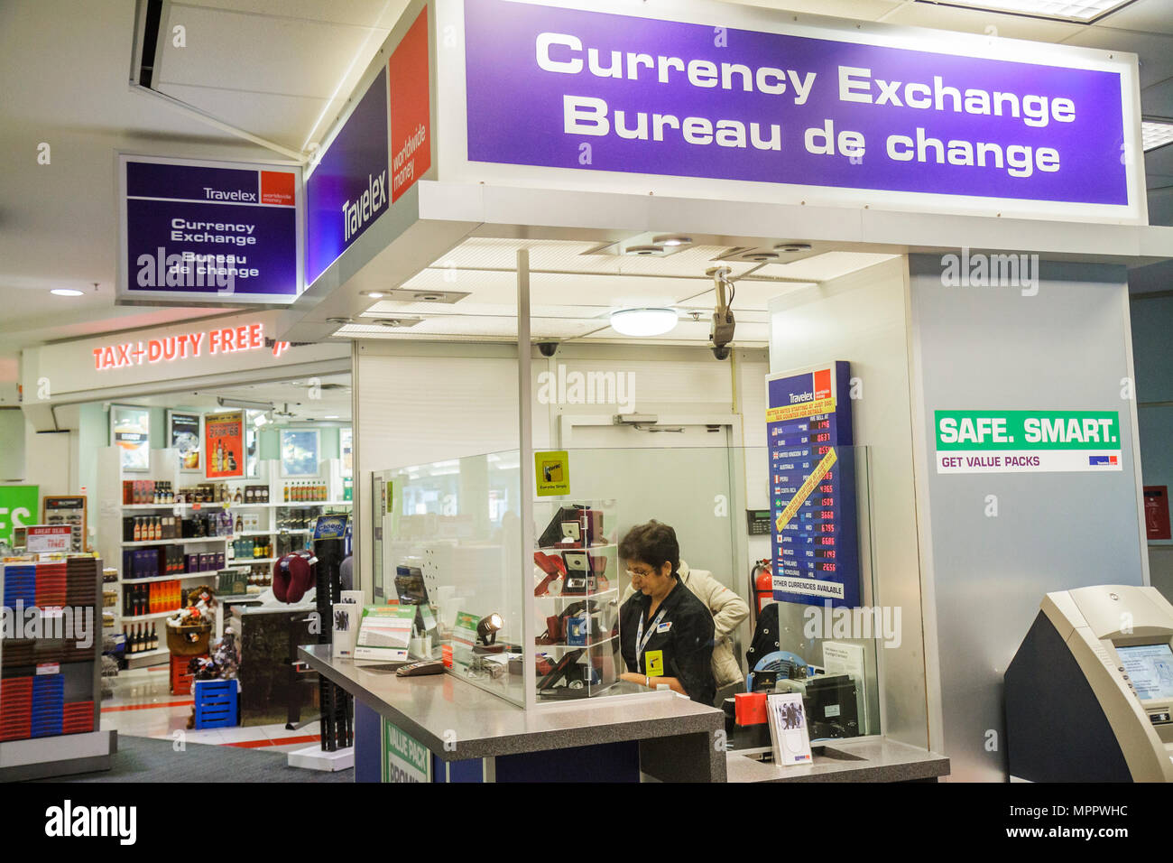 Toronto Canada,Lester B. Pearson International Airport,YYZ,aviation,terminal,currency exchange booth,foreign money,woman female women,cashier,working, Stock Photo