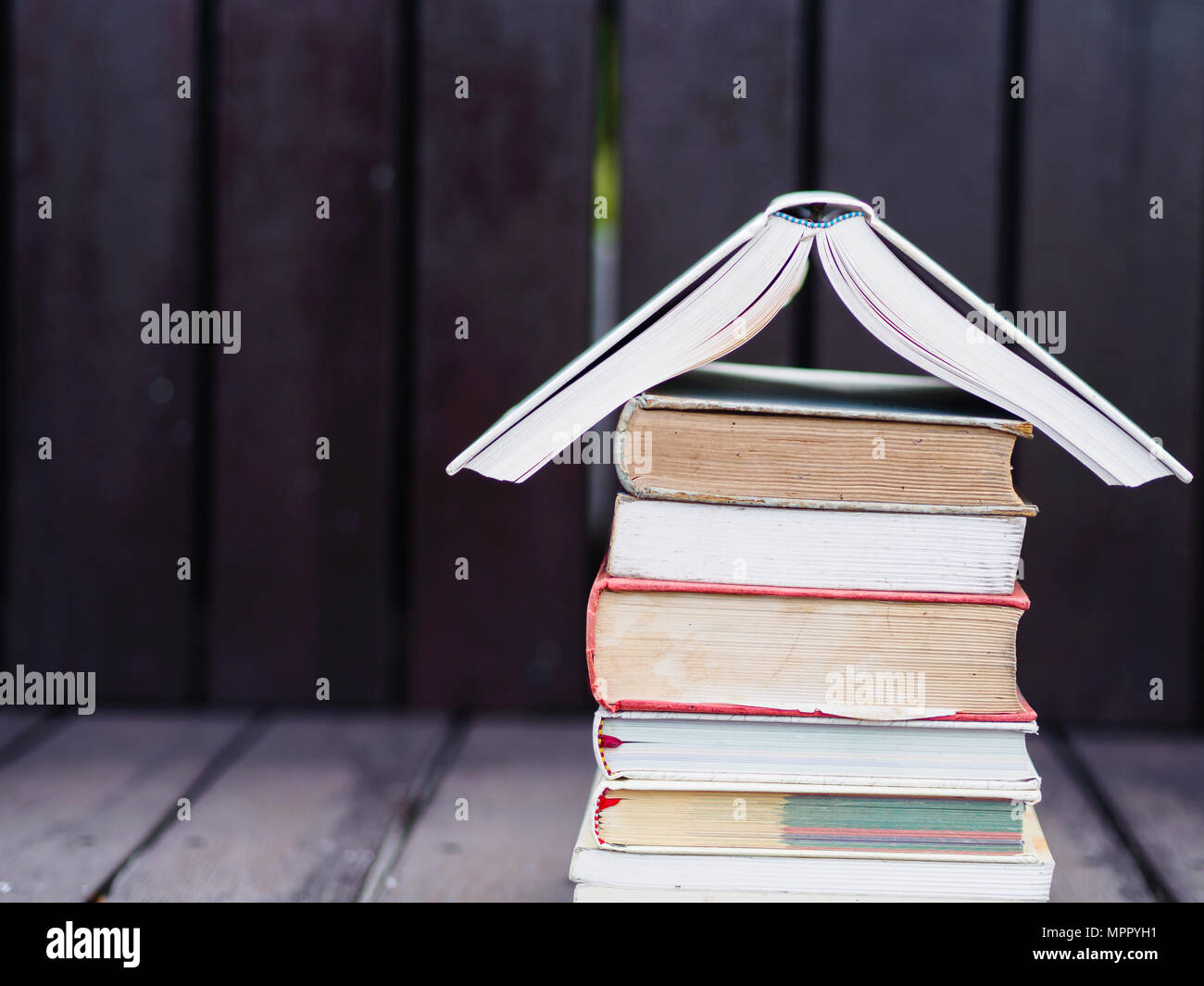 Closed up stack of books with wooden blackground Stock Photo - Alamy