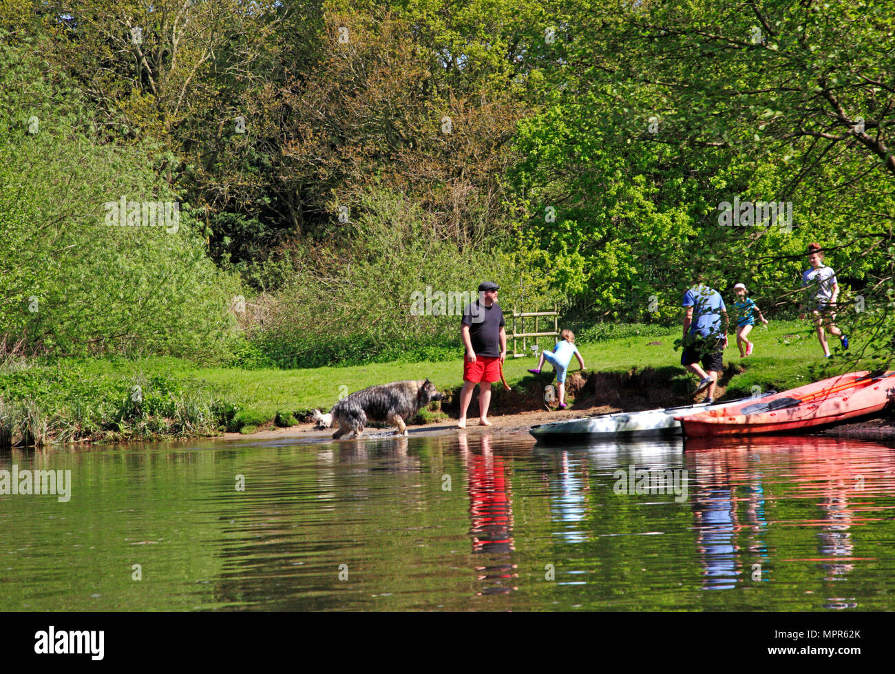 A family having fun by the River Bure on the Norfolk Broads near Wroxham, Norfolk, England, United Kingdom, Europe. Stock Photo