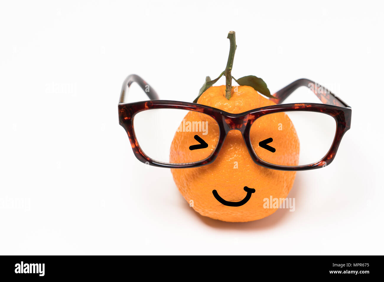 smiley orange wearing the eyeglasses on white backgrounds. cartoon emotion face orange isolated Stock Photo