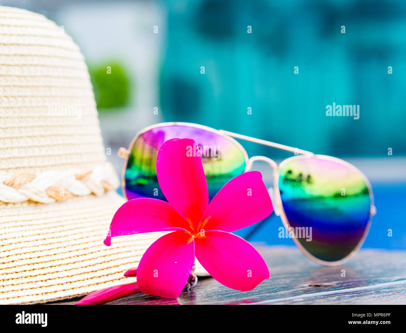 Red frangipani (plumeria) flowers with summer hat and sunglasses by the ...
