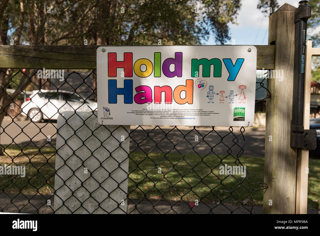A Hold My Hand sign at a park exit in Ku-Ring-Gai on Sydney's north shore. This is a road safety initiative to protect children under 10 years of age. Stock Photo