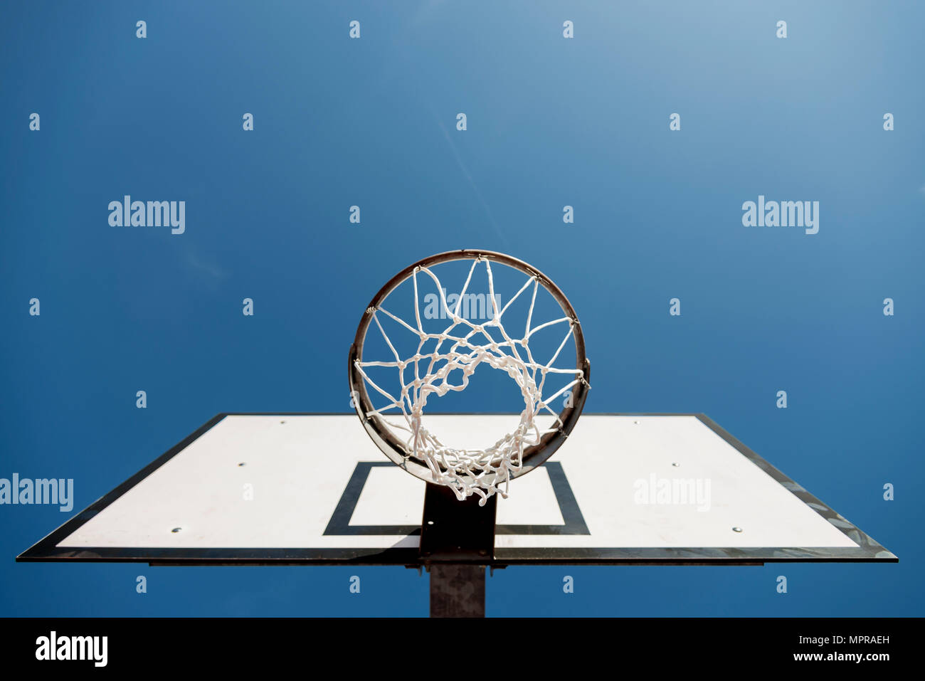 Basketball hoop against blue sky Stock Photo