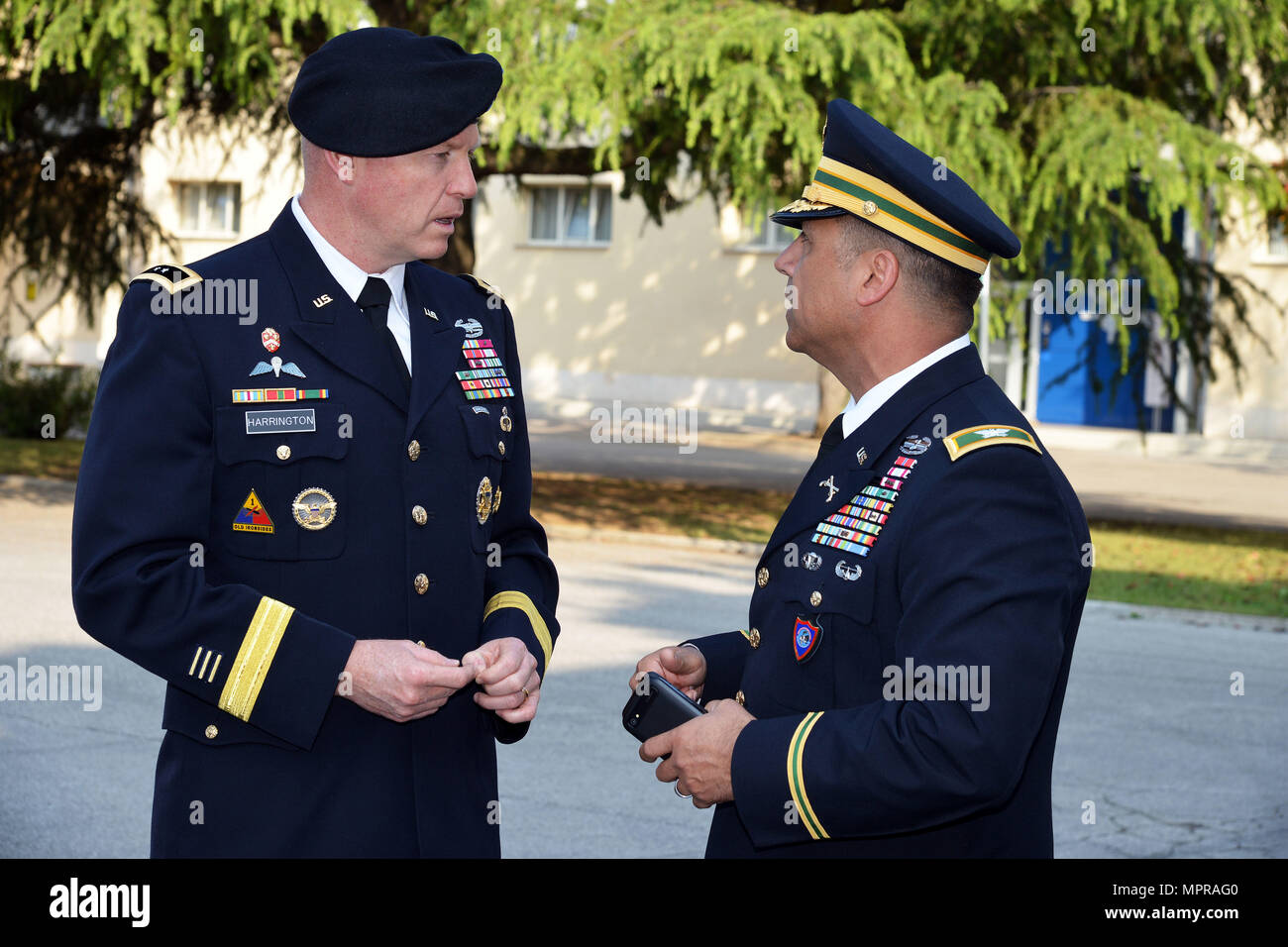 U.S. Army Col. Darius S. Gallegos (right), Center of Excellence for Stability Police Units (CoESPU) deputy director, talks with Maj. Gen. Joseph P. Harrington, U.S. Army Africa Commanding General, during the visit NATO JFC-Naples Commander, Admiral Michelle Howard at the CoESPU Vicenza, April 10, 2017. (U.S. Army Photo by Visual Information Specialist Paolo Bovo/released) Stock Photo