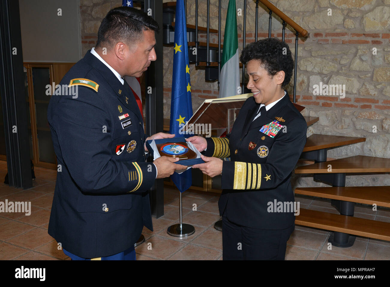 U.S. Army Col. Darius S. Gallegos, CoESPU deputy director (left), presents Carabinieri CoESPU crest to Admiral Michelle Howard, NATO JFC-Naples Commander, during the visit at the Center of Excellence for Stability Police Units (CoESPU) Vicenza, April 10, 2017. (U.S. Army Photo by Visual Information Specialist Paolo Bovo/released) Stock Photo