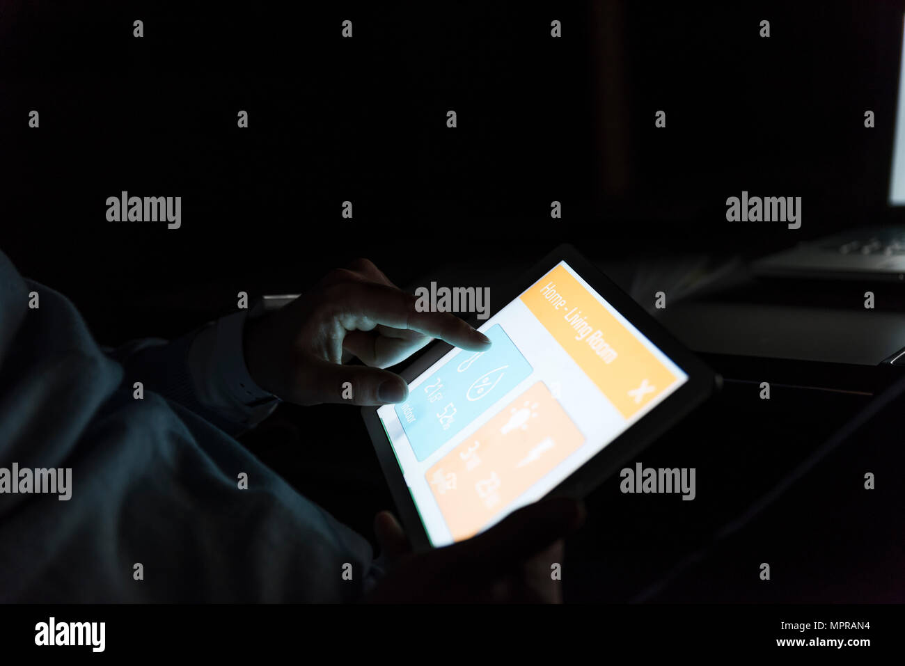 Businessman working on tablet at dark, close-up Stock Photo