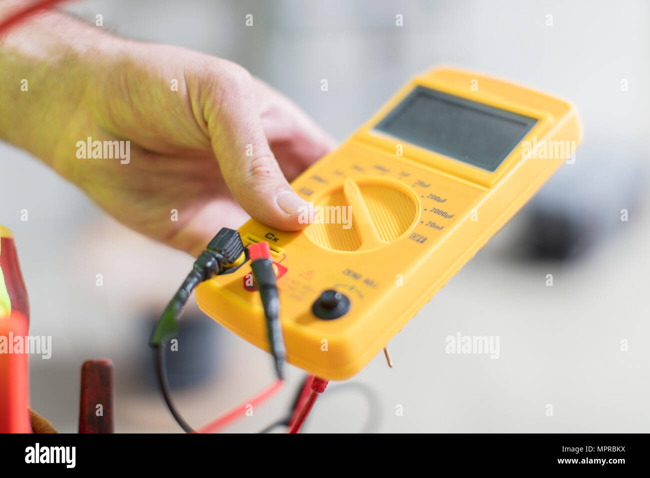 Close-up of electrician holding voltmeter Stock Photo