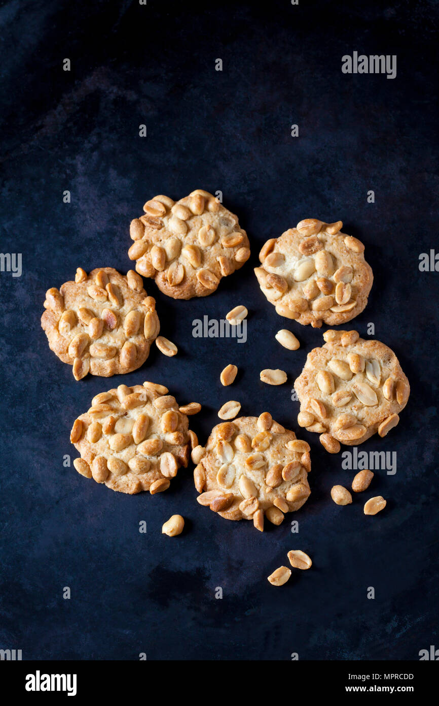 Six peanut cookies on dark metal Stock Photo