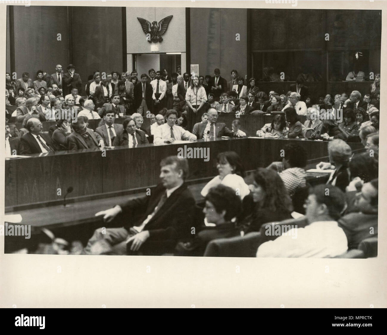 Objective Program Room At USAID, employees gathered in a conference room for a meeting focused ...