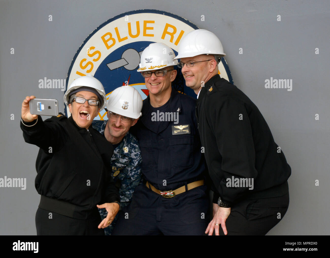 170407-N-DF478-076  YOKOSUKA, Japan (April 7, 2017)  U.S. Pacific Fleet, Command Master Chief Susan A. Whitman (left), USS Blue Ridge (LCC 19) Command Master Chief, CMDCM Charles F. Ziervogel , USS Blue Ridge Commanding Officer, Captain Matthew C. Paradise(center right) and U.S. Command 7th Fleet Command Master Chief, CMDCM Benjamin T. Howat (right) pose for a selfie in front of the ship logo during a ship tour. Blue Ridge is in an extensive maintenance period in order to modernize the ship to continue to serve as a robust communications platform in the U.S. 7th Fleet area of operations. (U.S. Stock Photo