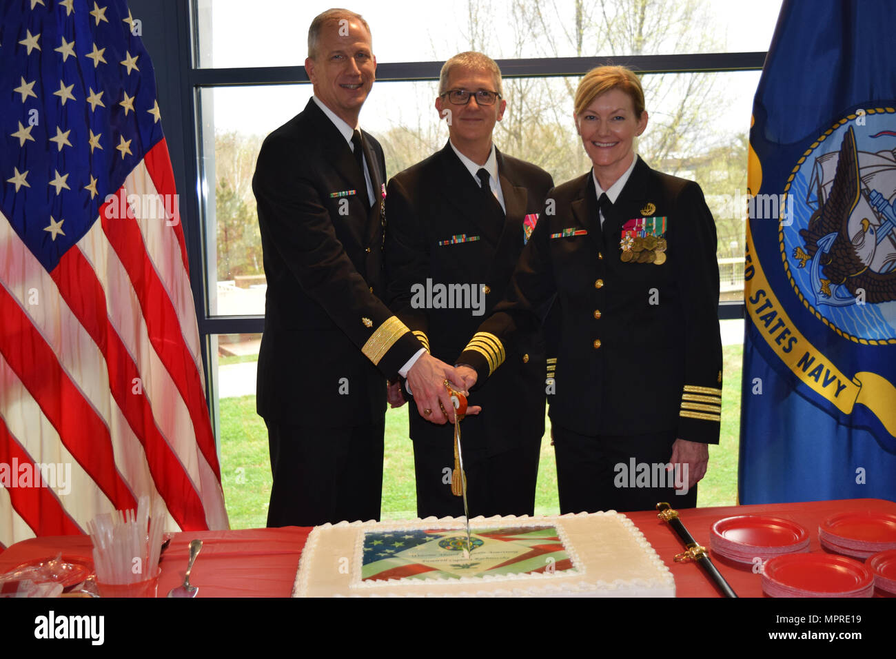 VIRIN: 170406-N-LJ212-056 SILVER SPRING (April 6, 2017) Rear Admiral Paul D. Pearigen, Commander, Navy Medicine West, Captain Adam W. Armstrong, Commanding Officer, Naval Medical Research Center, and Captain Jacqueline D. Rychnovsky celebrate the Naval Medical Research Center change of command and retirement of Captain Rychnovsky. Captain Rychnovsky relinquished command to Captain Adam W. Armstrong. ( U.S. Navy Photo by Public Affairs Specialist Katherine Berland/Released) Stock Photo