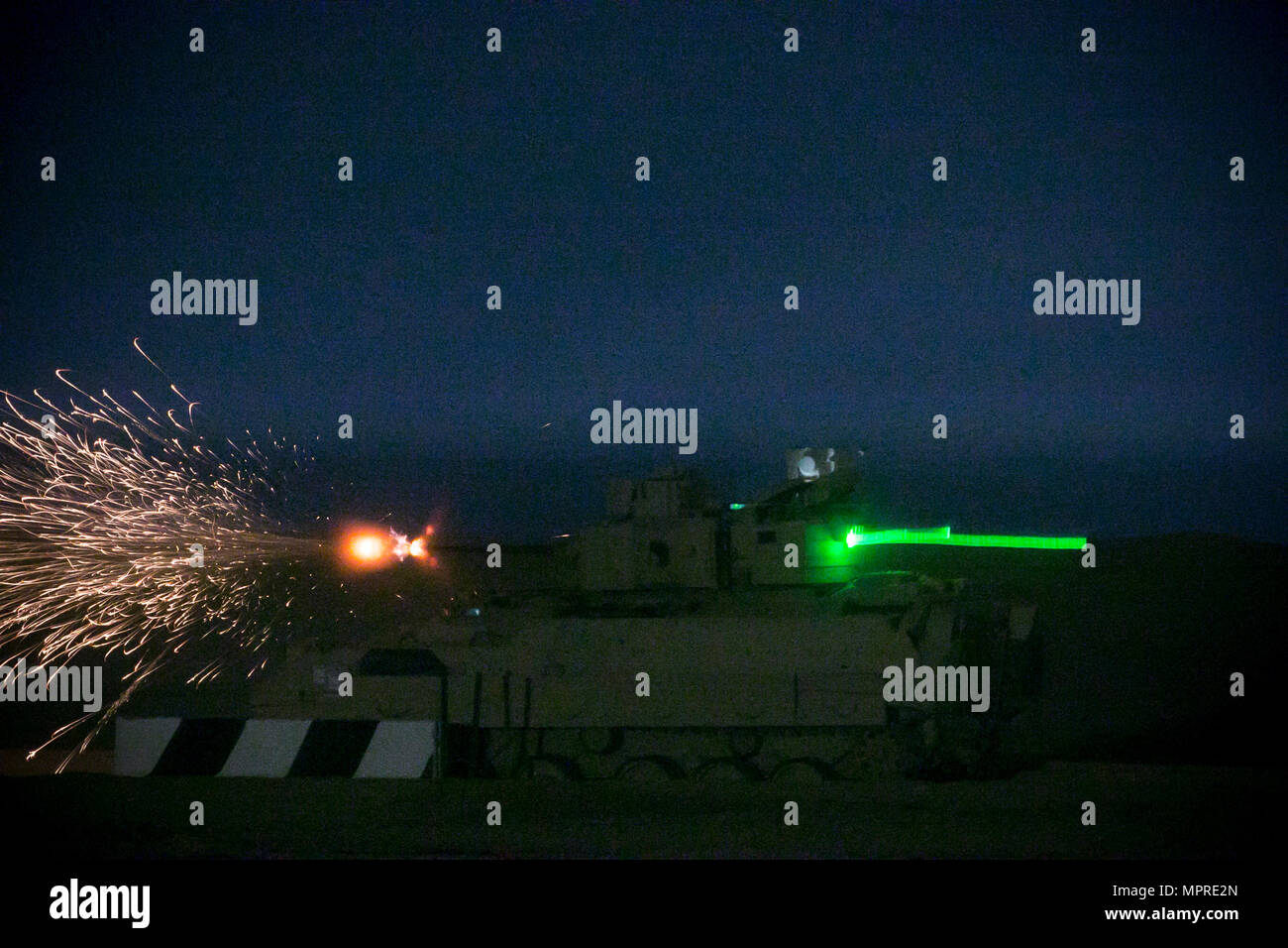 An M2A3 Bradley Fighting Vehicle crew from the 3rd Armored Brigade Combat Team, 1st Cavalry Division shoots at target during the night fire portion of Table VI qualifications at the Udairi Range Complex March 29. The brigade tank and Bradley crews spent about two weeks in the field conducting sustainment gunnery to ensure all the crews qualified at day and night fire to maintain proficiency. (U.S. Army photo by Staff Sgt. Leah R. Kilpatrick, 3rd Armored Brigade Combat Team Public Affairs Office, 1st Cavalry Division (released) Stock Photo